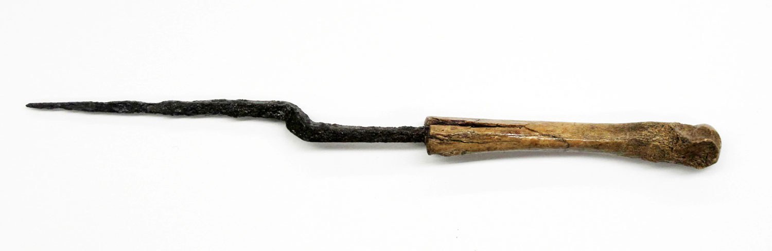An iron offset awl with a bone handle shows a combination of aboriginal and European technologies.