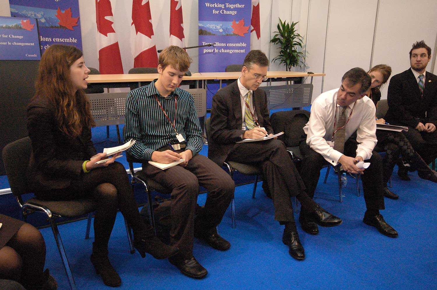 Meagan (left) discusses Canadian climate change policies with MP Jim Prentice (third from right) and Canadian negotiators at the United Nations Framework Convention on Climate Change in December 2008.