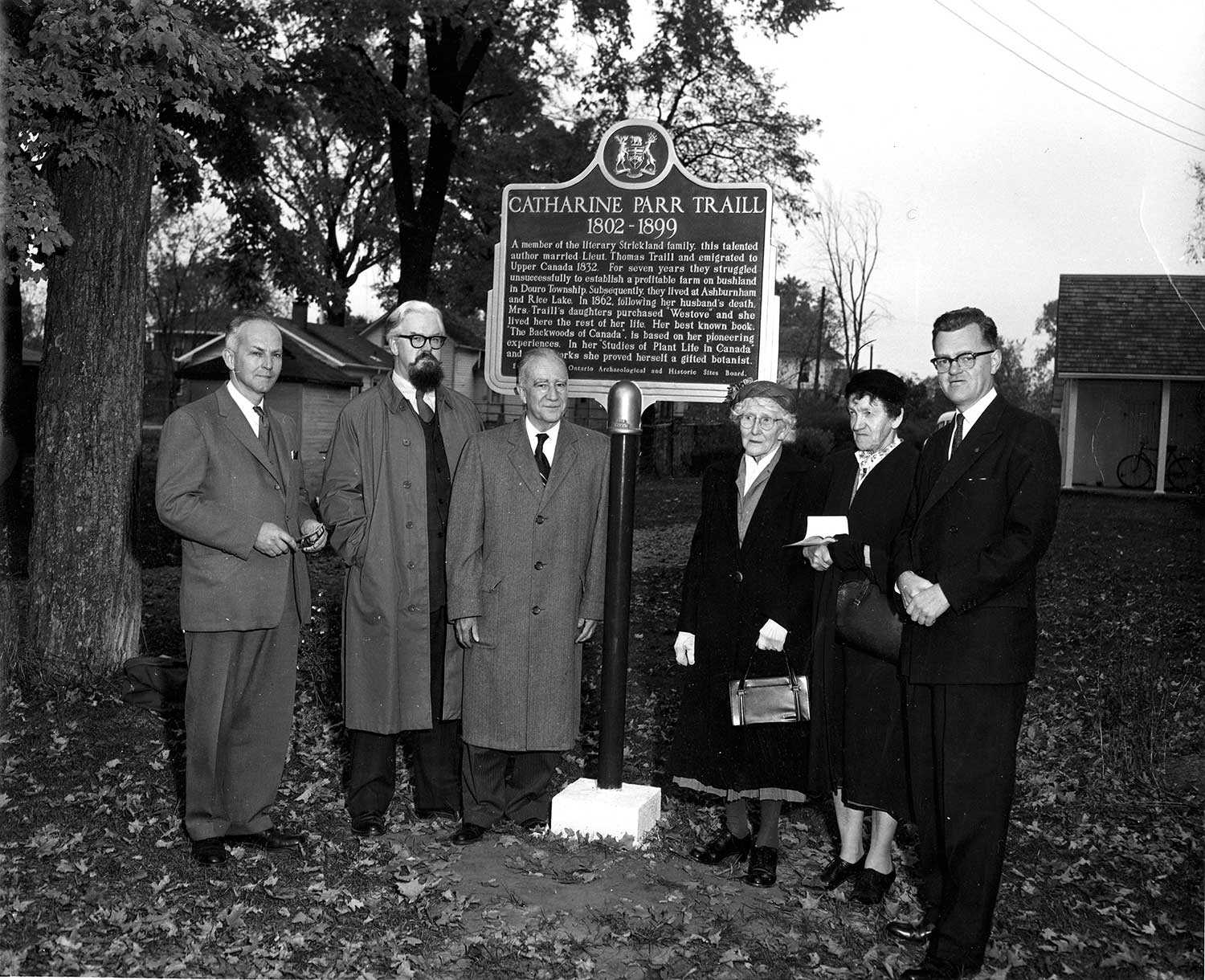 This 1958 provincial plaque unveiling to commemorate Catharine Parr Traill was attended by Mrs. Anne Atwood and Miss Anne Traill, the author’s granddaughters. Also in attendance (shown here second from left) was the then-editor of the Peterborough Examiner – Robertson Davies – who, in time, became a literary giant in his own right.